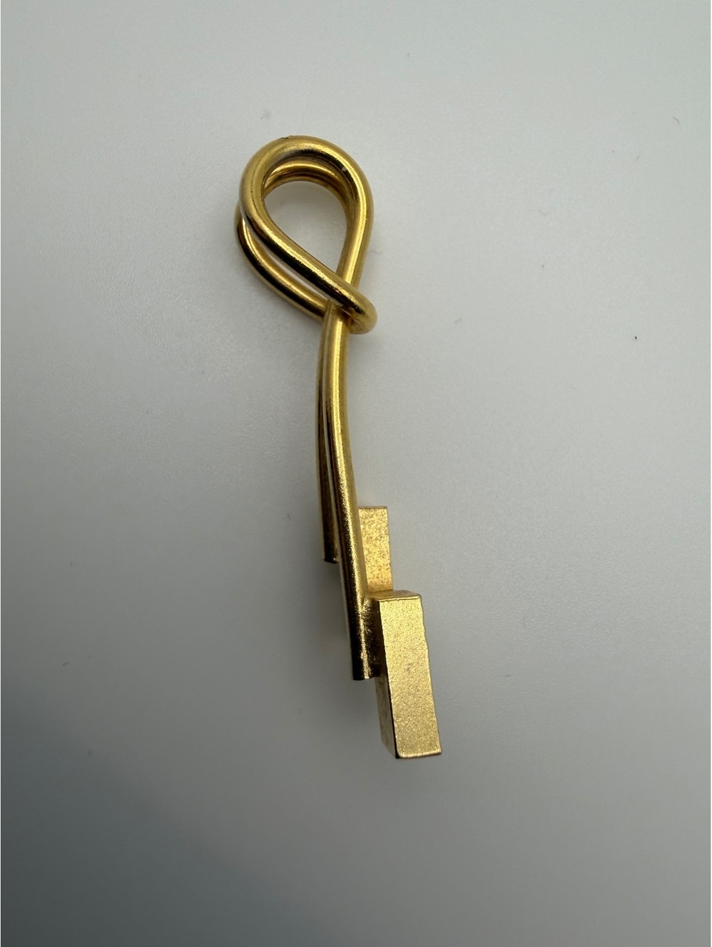 Gold tone geometric loop necklace charm